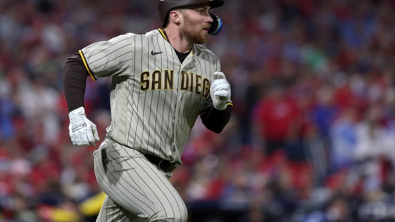 Oct 22, 2022; Philadelphia, Pennsylvania, USA; San Diego Padres first baseman Brandon Drury (17) watches his two-RBI double in the first inning during game four of the NLCS against the Philadelphia Phillies for the 2022 MLB Playoffs at Citizens Bank Park. Mandatory Credit: Bill Streicher-USA TODAY Sports