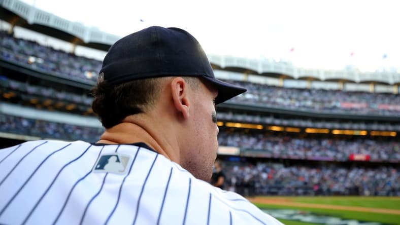 Oct 22, 2022; Bronx, New York, USA; New York Yankees right fielder Aaron Judge (99) looks out of the dugout before taking the field for the start of game three of the ALCS against the Houston Astros during the 2022 MLB Playoffs at Yankee Stadium. Mandatory Credit: Brad Penner-USA TODAY Sports