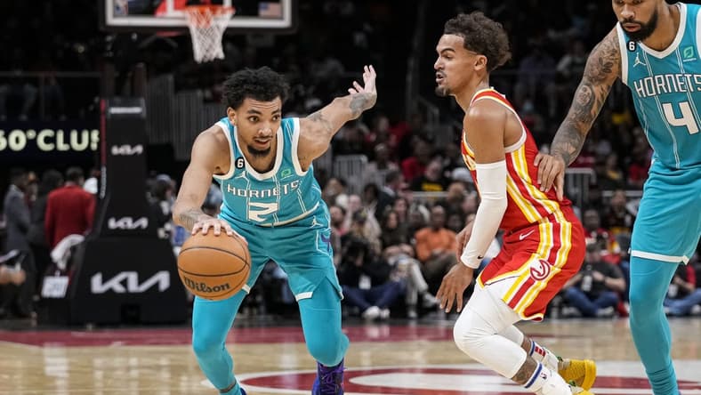 Oct 23, 2022; Atlanta, Georgia, USA; Charlotte Hornets guard James Bouknight (2) dribbles past Atlanta Hawks guard Trae Young (11) during the second half at State Farm Arena. Mandatory Credit: Dale Zanine-USA TODAY Sports