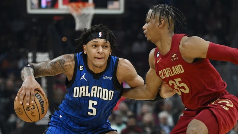 Oct 26, 2022; Cleveland, Ohio, USA; Orlando Magic forward Paolo Banchero (5) drives to the basket against Cleveland Cavaliers forward Isaac Okoro (35) during the first half at Rocket Mortgage FieldHouse. Mandatory Credit: Ken Blaze-USA TODAY Sports
