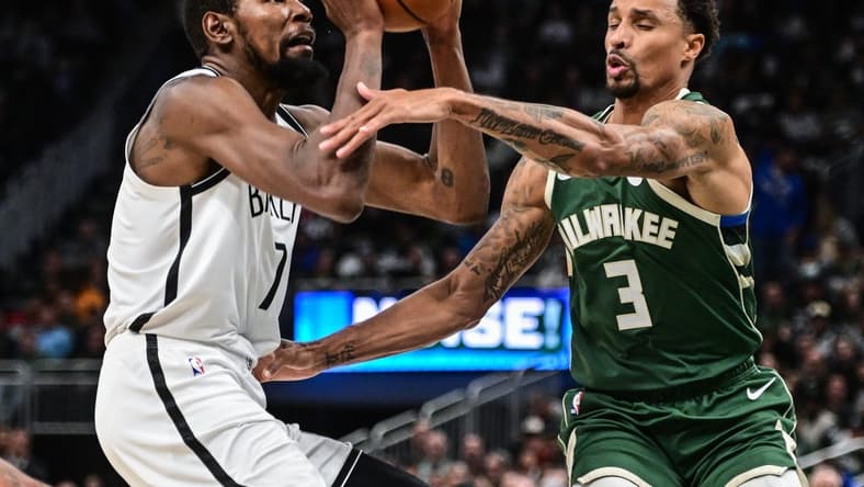 Oct 26, 2022; Milwaukee, Wisconsin, USA; Brooklyn Nets forward Kevin Durant (7) takes a shot against Milwaukee Bucks guard George Hill (3) in the third quarter at Fiserv Forum. Mandatory Credit: Benny Sieu-USA TODAY Sports
