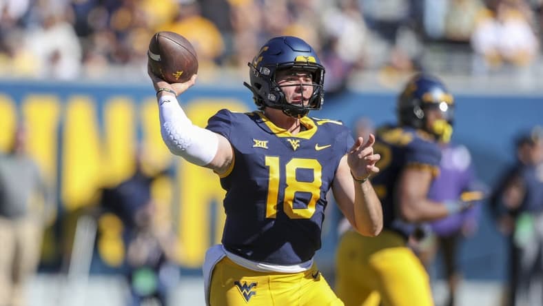 Oct 29, 2022; Morgantown, West Virginia, USA; West Virginia Mountaineers quarterback JT Daniels (18) throws a pass during the second quarter against the TCU Horned Frogs at Mountaineer Field at Milan Puskar Stadium. Mandatory Credit: Ben Queen-USA TODAY Sports