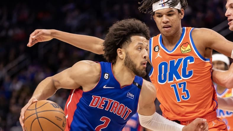 Nov 7, 2022; Detroit, Michigan, USA; Oklahoma City Thunder forward Ousmane Dieng (13) defends against Detroit Pistons guard Cade Cunningham (2) during the second half at Little Caesars Arena. Mandatory Credit: David Reginek-USA TODAY Sports