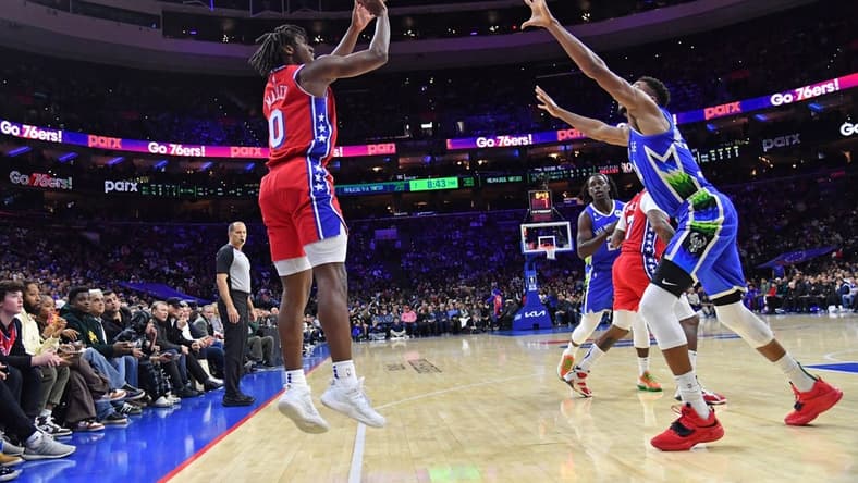 Nov 18, 2022; Philadelphia, Pennsylvania, USA; Philadelphia 76ers guard Tyrese Maxey (0) shoots over Milwaukee Bucks forward Giannis Antetokounmpo (34) during the second quarter at Wells Fargo Center. Mandatory Credit: Eric Hartline-USA TODAY Sports