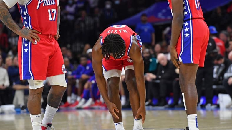 Nov 18, 2022; Philadelphia, Pennsylvania, USA; Philadelphia 76ers guard Tyrese Maxey (0) reaches for his ankle he hurt against the Milwaukee Bucks during the second quarter at Wells Fargo Center. Mandatory Credit: Eric Hartline-USA TODAY Sports