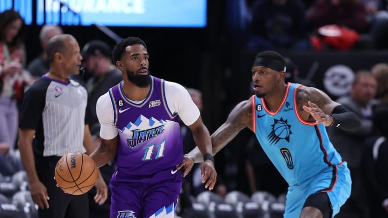 Nov 18, 2022; Salt Lake City, Utah, USA; Utah Jazz guard Mike Conley (11) looks to pass the ball against Phoenix Suns forward Torrey Craig (0) in the first half at Vivint Arena. Mandatory Credit: Rob Gray-USA TODAY Sports