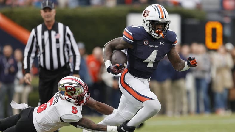 Nov 19, 2022; Auburn, Alabama, USA; Western Kentucky Hilltoppers defensive back Rome Weber (5) grabs Auburn Tigers running back Tank Bigsby (4) during the first quarter at Jordan-Hare Stadium. Mandatory Credit: John Reed-USA TODAY Sports