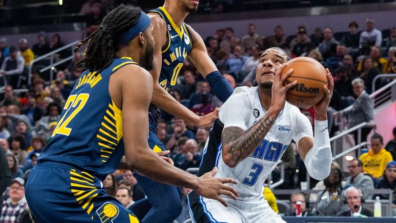 Nov 19, 2022; Indianapolis, Indiana, USA; Orlando Magic forward Chuma Okeke (3) shoots the ball against Indiana Pacers guard Tyrese Haliburton (0) and forward Isaiah Jackson (22) in the first quarter at Gainbridge Fieldhouse. Mandatory Credit: Trevor Ruszkowski-USA TODAY Sports