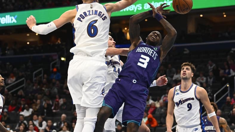 Nov 20, 2022; Washington, District of Columbia, USA; Washington Wizards center Kristaps Porzingis (6) blocks the shot of Charlotte Hornets guard Terry Rozier (3) during the second half at Capital One Arena. Mandatory Credit: Brad Mills-USA TODAY Sports