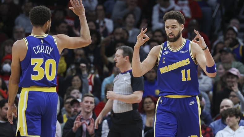 Nov 20, 2022; Houston, Texas, USA; Golden State Warriors guard Klay Thompson (11) and guard Stephen Curry (30) celebrate after a play during the first quarter against the Houston Rockets at Toyota Center. Mandatory Credit: Troy Taormina-USA TODAY Sports