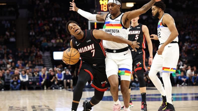 Nov 21, 2022; Minneapolis, Minnesota, USA; Miami Heat guard Kyle Lowry (7) dribbles the ball while Minnesota Timberwolves forward Jaden McDaniels (3) defends during the first quarter at Target Center. Mandatory Credit: Matt Krohn-USA TODAY Sports