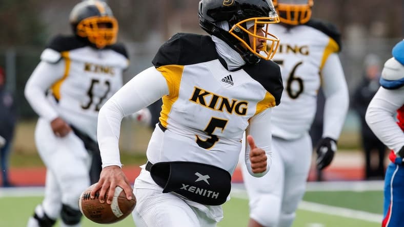 Detroit King quarterback Dante Moore (5) runs against Mason during the second half of Division 3 state semifinal at John Glenn High School in Westland on Saturday, Nov. 19, 2022.
