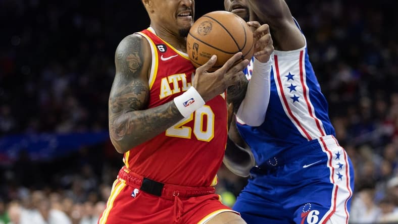 Nov 28, 2022; Philadelphia, Pennsylvania, USA; Atlanta Hawks forward John Collins (20) drives against Philadelphia 76ers guard Shake Milton (18) during the first quarter at Wells Fargo Center. Mandatory Credit: Bill Streicher-USA TODAY Sports