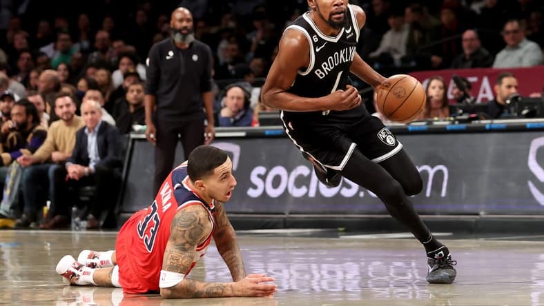 Nov 30, 2022; Brooklyn, New York, USA; Brooklyn Nets forward Kevin Durant (7) drives to the basket against Washington Wizards forward Kyle Kuzma (33) during the first quarter at Barclays Center. Mandatory Credit: Brad Penner-USA TODAY Sports