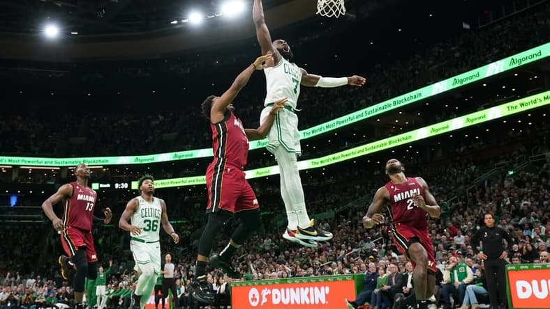 Nov 30, 2022; Boston, Massachusetts, USA; Boston Celtics guard Jaylen Brown (7) makes the dunk against Miami Heat guard Kyle Lowry (7) in the second half at TD Garden. Mandatory Credit: David Butler II-USA TODAY Sports