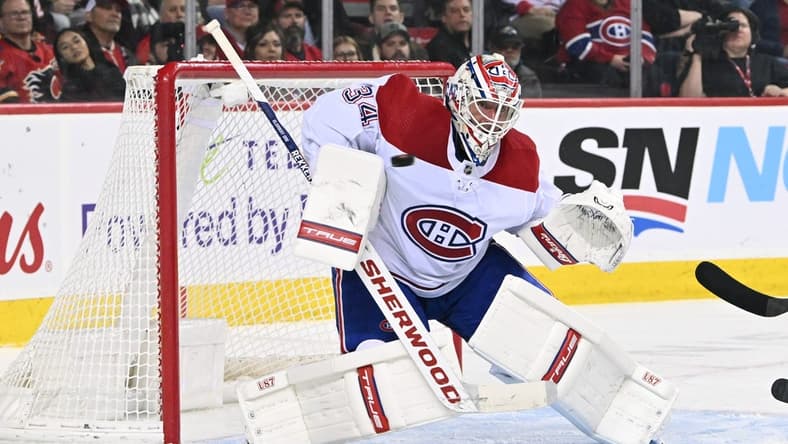 Dec 1, 2022; Calgary, Alberta, CAN; Montreal Canadiens goalie Jake Allen (34) stops a shot from the Calgary Flames in the second period at Scotiabank Saddledome. Mandatory Credit: Candice Ward-USA TODAY Sports