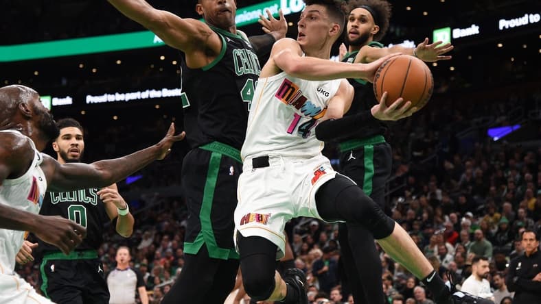 Dec 2, 2022; Boston, Massachusetts, USA; Miami Heat guard Tyler Herro (14) looks to pass the ball while Boston Celtics center Al Horford (42) defends during the first half at TD Garden. Mandatory Credit: Bob DeChiara-USA TODAY Sports