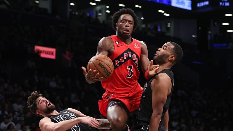 Dec 2, 2022; Brooklyn, New York, USA; Toronto Raptors forward O.G. Anunoby (3) draws a charge ob Brooklyn Nets forward Joe Harris (12) and forward T.J. Warren (1) during the first half at Barclays Center. Mandatory Credit: Vincent Carchietta-USA TODAY Sports