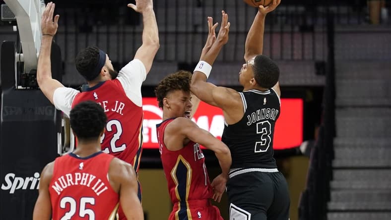 Dec 2, 2022; San Antonio, Texas, USA; San Antonio Spurs forward Keldon Johnson (3) shoots over New Orleans Pelicans guard Dyson Daniels (11) and forward Larry Nance Jr. (22) during the first half at AT&T Center. Mandatory Credit: Scott Wachter-USA TODAY Sports