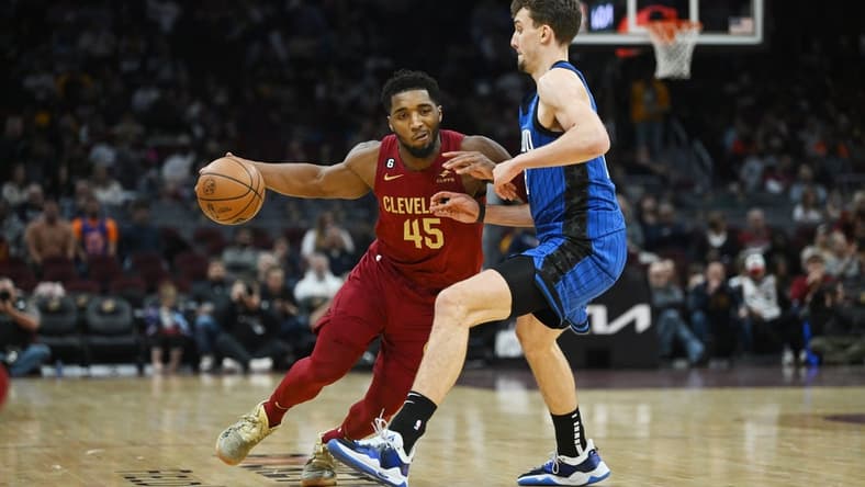 Dec 2, 2022; Cleveland, Ohio, USA; Cleveland Cavaliers guard Donovan Mitchell (45) drives to the basket against Orlando Magic forward Franz Wagner (22) during the second half at Rocket Mortgage FieldHouse. Mandatory Credit: Ken Blaze-USA TODAY Sports