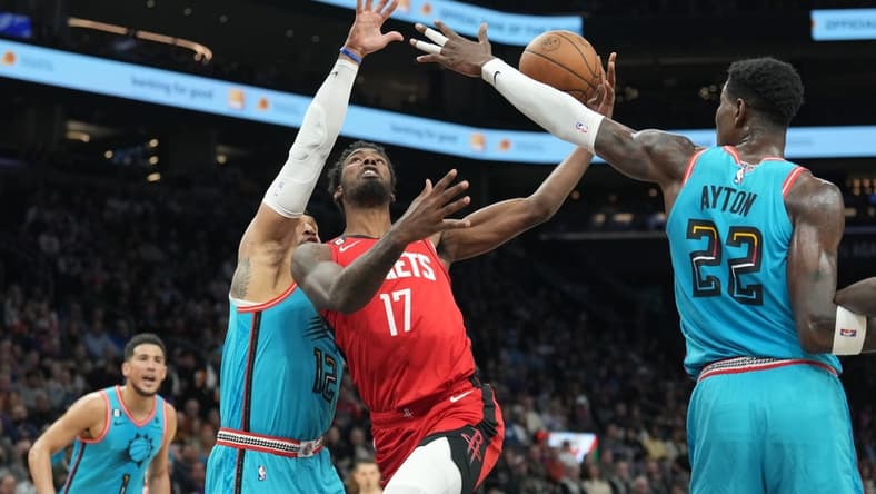 Dec 2, 2022; Phoenix, Arizona, USA; Houston Rockets forward Tari Eason (17) drives against Phoenix Suns forward Ish Wainright (12) and Phoenix Suns center Deandre Ayton (22) during the first half at Footprint Center. Mandatory Credit: Joe Camporeale-USA TODAY Sports
