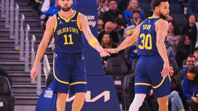 Dec 2, 2022; San Francisco, California, USA; Golden State Warriors shooting guard Klay Thompson (11) and point guard Stephen Curry (30) high five after Thompson scored with an assist from Curry during the first quarter against the Chicago Bulls at Chase Center. Mandatory Credit: Kelley L Cox-USA TODAY Sports