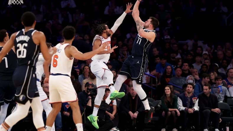 Dec 3, 2022; New York, New York, USA; Dallas Mavericks guard Luka Doncic (77) shoots over New York Knicks guard Jalen Brunson (11) during the third quarter at Madison Square Garden. Mandatory Credit: Brad Penner-USA TODAY Sports