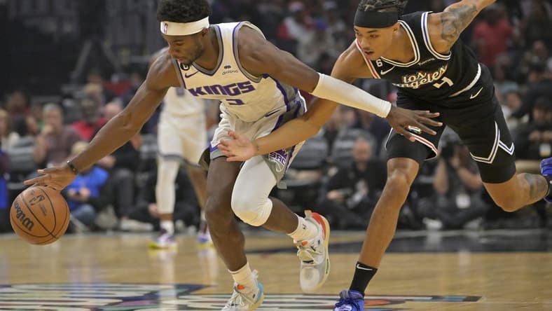 Dec 3, 2022; Los Angeles, California, USA;  Sacramento Kings guard Terence Davis (3) and Los Angeles Clippers guard Brandon Boston Jr. (4) chase down a loose ball in the first half at Crypto.com Arena. Mandatory Credit: Jayne Kamin-Oncea-USA TODAY Sports