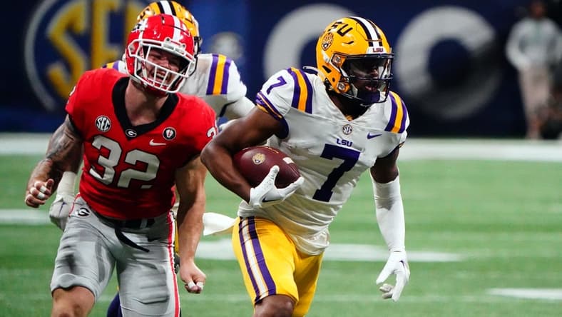 Dec 3, 2022; Atlanta, GA, USA; LSU Tigers wide receiver Kayshon Boutte (7) carries the ball for a receiving touchdown against the Georgia Bulldogs during the first quarter of the SEC Championship game at Mercedes-Benz Stadium. Mandatory Credit: John David Mercer-USA TODAY Sports