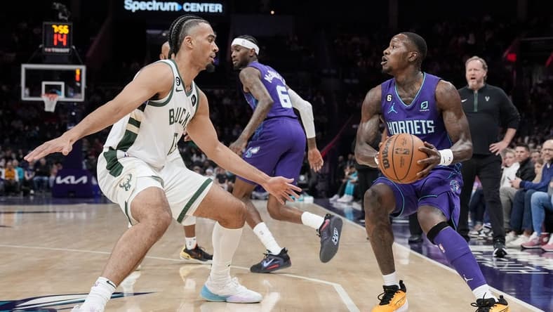 Dec 3, 2022; Charlotte, North Carolina, USA; Charlotte Hornets guard Terry Rozier (3) looks to shoot over Milwaukee Bucks forward Jordan Nwora (13) during the first half at the Spectrum Center. Mandatory Credit: Jim Dedmon-USA TODAY Sports