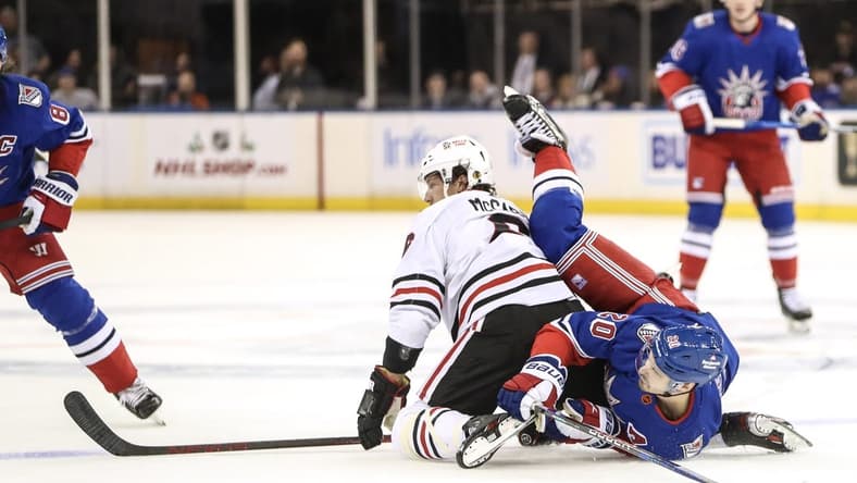 Dec 3, 2022; New York, New York, USA;  Chicago Blackhawks defenseman Jake McCabe (6) and New York Rangers left wing Chris Kreider (20) collide on the ice in the first period at Madison Square Garden. Mandatory Credit: Wendell Cruz-USA TODAY Sports