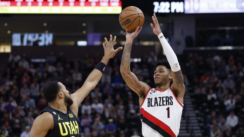 Dec 3, 2022; Salt Lake City, Utah, USA; Portland Trail Blazers guard Anfernee Simons (1) shoots over Utah Jazz guard Talen Horton-Tucker (0) in the first quarter at Vivint Arena. Mandatory Credit: Jeffrey Swinger-USA TODAY Sports