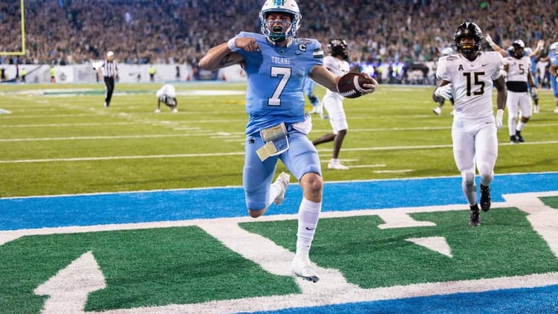 Dec 3, 2022; New Orleans, Louisiana, USA; Tulane Green Wave quarterback Michael Pratt (7) rushes in for a touchdown against the UCF Knights during the second half  at Yulman Stadium. Mandatory Credit: Stephen Lew-USA TODAY Sports