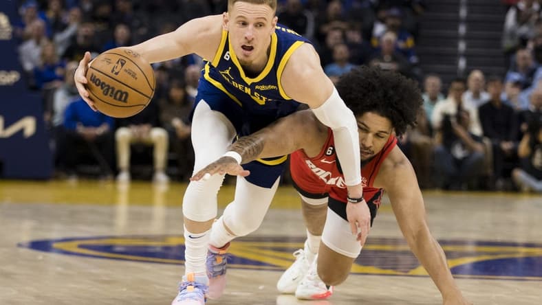 Dec 3, 2022; San Francisco, California, USA; Golden State Warriors guard Donte DiVincenzo (0) gains possession of the ball against Houston Rockets guard Daishen Nix (15) during the first half at Chase Center. Mandatory Credit: John Hefti-USA TODAY Sports