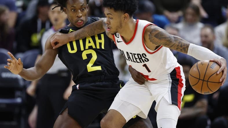 Dec 3, 2022; Salt Lake City, Utah, USA; Utah Jazz guard Collin Sexton (2) guards Portland Trail Blazers guard Anfernee Simons (1) in the second half at Vivint Arena. Mandatory Credit: Jeffrey Swinger-USA TODAY Sports