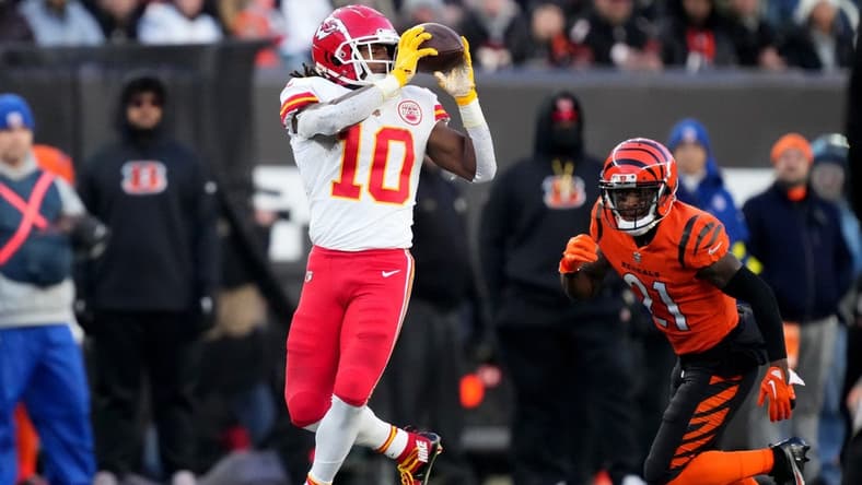 Dec 4, 2022; Cincinnati, Ohio, USA; Kansas City Chiefs running back Isiah Pacheco (10) completes catch as Cincinnati Bengals cornerback Mike Hilton (21) defends in the first quarter of a Week 13 NFL game at Paycor Stadium. Mandatory Credit: Kareem Elgazzar-USA TODAY Sports