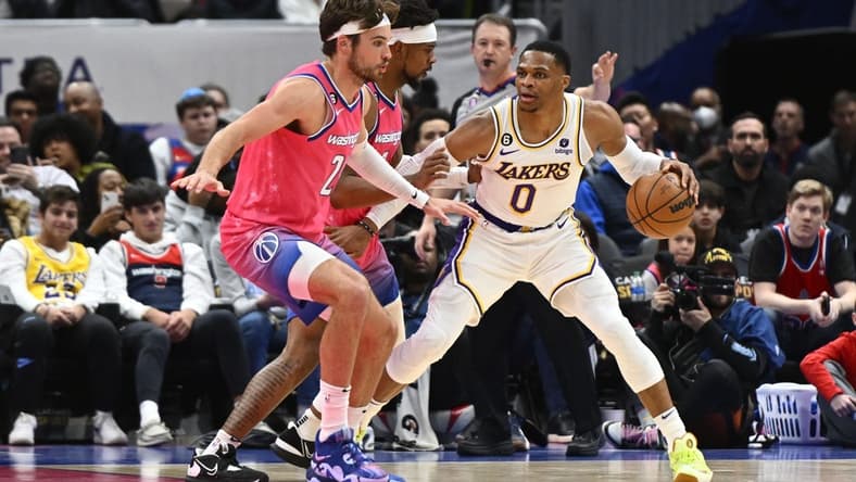 Dec 4, 2022; Washington, District of Columbia, USA; Los Angeles Lakers guard Russell Westbrook (0) dribbles as Washington Wizards forward Corey Kispert (24) looks on during the first half at Capital One Arena. Mandatory Credit: Brad Mills-USA TODAY Sports