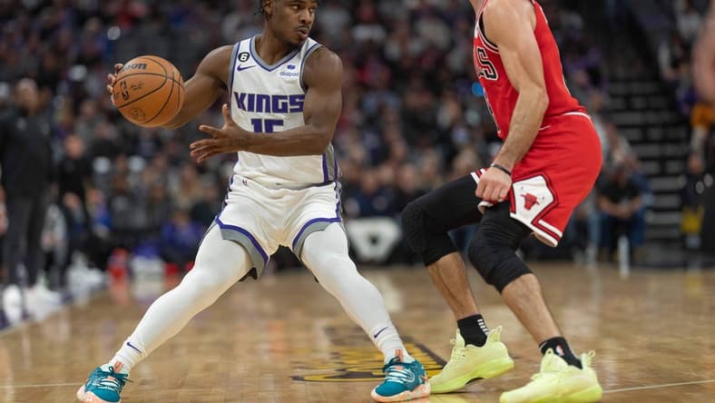 Dec 4, 2022; Sacramento, California, USA; Sacramento Kings guard Davion Mitchell (15) looks to pass the ball during the second quarter against Chicago Bulls guard Alex Caruso (6) at Golden 1 Center. Mandatory Credit: Stan Szeto-USA TODAY Sports