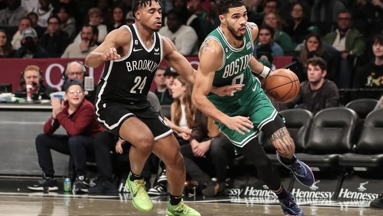 Dec 4, 2022; Brooklyn, New York, USA; Boston Celtics forward Jayson Tatum (0) drives past Brooklyn Nets guard Cam Thomas (24) in the second quarter at Barclays Center. Mandatory Credit: Wendell Cruz-USA TODAY Sports