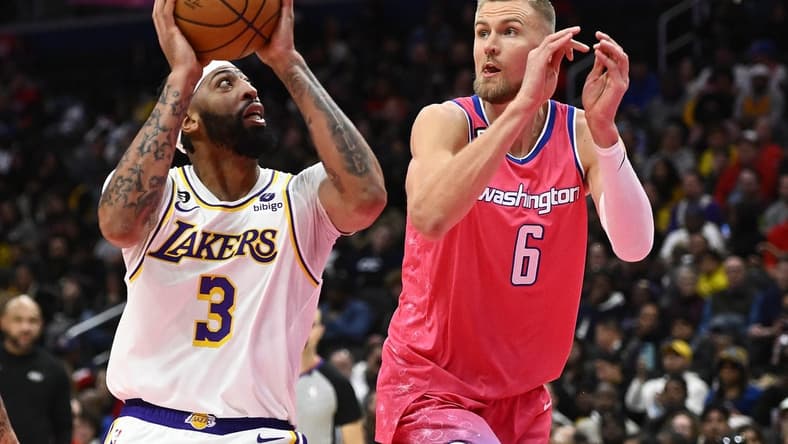 Dec 4, 2022; Washington, District of Columbia, USA; Los Angeles Lakers forward Anthony Davis (3) shoots as Washington Wizards center Kristaps Porzingis (6) defends during the second half at Capital One Arena. Mandatory Credit: Brad Mills-USA TODAY Sports