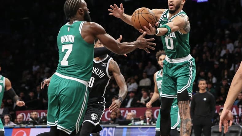 Dec 4, 2022; Brooklyn, New York, USA; Boston Celtics guard Jaylen Brown (7) and forward Jayson Tatum (0) reach for the ball in the fourth quarter against the Brooklyn Nets at Barclays Center. Mandatory Credit: Wendell Cruz-USA TODAY Sports