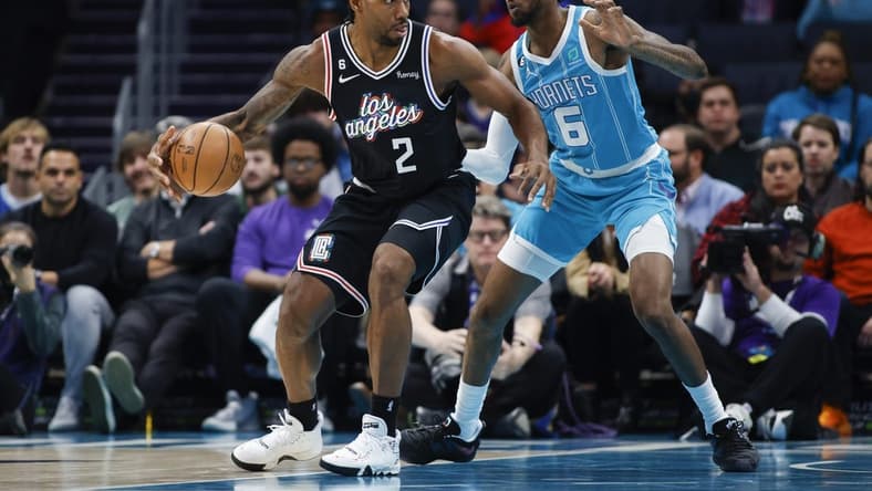 Dec 5, 2022; Charlotte, North Carolina, USA; Los Angeles Clippers forward Kawhi Leonard (2) drives against Charlotte Hornets forward Jalen McDaniels (6) during the first half at Spectrum Center. Mandatory Credit: Nell Redmond-USA TODAY Sports