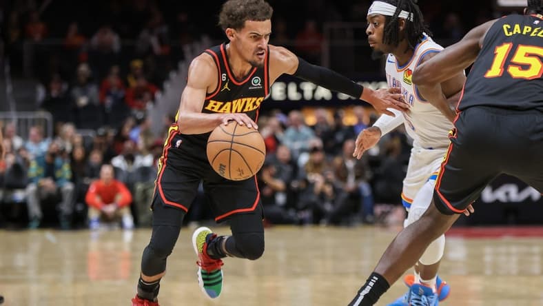 Dec 5, 2022; Atlanta, Georgia, USA; Atlanta Hawks guard Trae Young (11) drives on Oklahoma City Thunder forward Luguentz Dort (5) in the first quarter at State Farm Arena. Mandatory Credit: Brett Davis-USA TODAY Sports