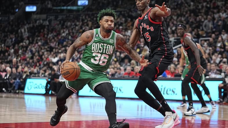 Dec 5, 2022; Toronto, Ontario, CAN; Boston Celtics guard Marcus Smart (36) drives to the net against Toronto Raptors forward Christian Koloko (35) during the first half at Scotiabank Arena. Mandatory Credit: John E. Sokolowski-USA TODAY Sports