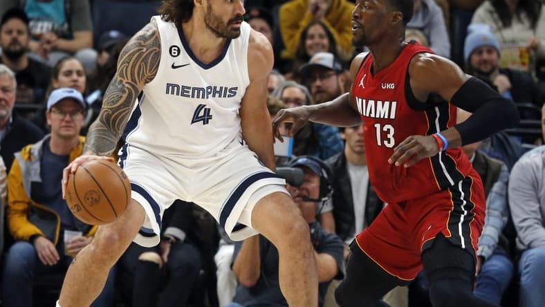Dec 5, 2022; Memphis, Tennessee, USA; Memphis Grizzlies center Steven Adams (4) dribbles as Miami Heat center Bam Adebayo (13) defends during the first half at FedExForum. Mandatory Credit: Petre Thomas-USA TODAY Sports