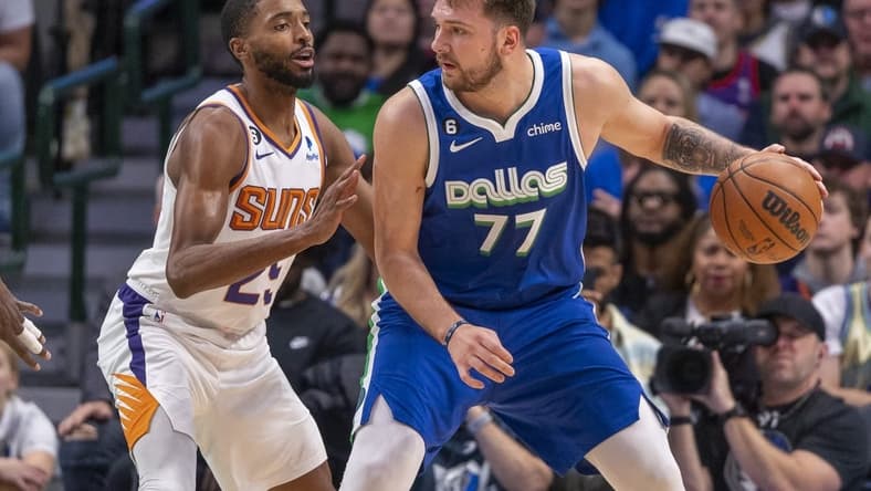 Dec 5, 2022; Dallas, Texas, USA; Phoenix Suns forward Mikal Bridges (25) guards Dallas Mavericks guard Luka Doncic (77) during the first quarter at the American Airlines Center. Mandatory Credit: Jerome Miron-USA TODAY Sports