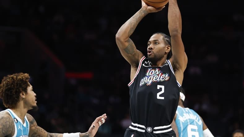 Dec 5, 2022; Charlotte, North Carolina, USA; Los Angeles Clippers forward Kawhi Leonard (2) shoots over Charlotte Hornets guard Kelly Oubre Jr. (12) during the second half at Spectrum Center. The Los Angeles Clippers won 119-117. at Spectrum Center. Mandatory Credit: Nell Redmond-USA TODAY Sports
