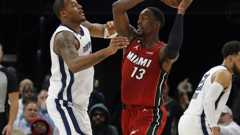 Dec 5, 2022; Memphis, Tennessee, USA; Miami Heat center Bam Adebayo (13) passes the ball as Memphis Grizzlies forward Xavier Tillman (2) defends during the second half at FedExForum. Mandatory Credit: Petre Thomas-USA TODAY Sports