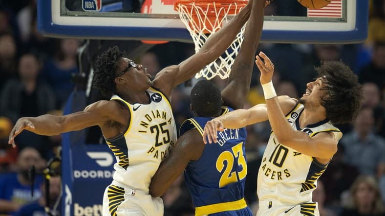 Dec 5, 2022; San Francisco, California, USA; Indiana Pacers forward Jalen Smith (25) and guard Kendall Brown (10) combine to block a shot by Golden State Warriors forward Draymond Green (23) during the first quarter at Chase Center. Mandatory Credit: D. Ross Cameron-USA TODAY Sports