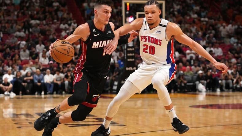 Dec 6, 2022; Miami, Florida, USA; Miami Heat guard Tyler Herro (14) drives the ball around Detroit Pistons forward Kevin Knox II (20) during the first half at FTX Arena. Mandatory Credit: Jasen Vinlove-USA TODAY Sports